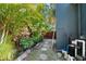 Lush backyard features a charming stone path, tropical foliage, and a gated fence at 1304 Withlacoochee St, Safety Harbor, FL 34695