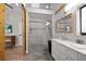 Modern bathroom featuring a glass shower, wood accents and a stylish vanity at 1304 Withlacoochee St, Safety Harbor, FL 34695
