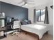 Modern bedroom with a dark accent wall, a ceiling fan, and light wood flooring, creating a serene space at 1304 Withlacoochee St, Safety Harbor, FL 34695
