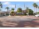 An inviting entrance to Safety Harbor Resort & Spa, framed by palm trees and American flags at 1304 Withlacoochee St, Safety Harbor, FL 34695