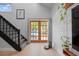 Foyer with staircase, wood-framed glass doors to a pool area and accent decor at 1304 Withlacoochee St, Safety Harbor, FL 34695