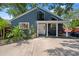 Inviting home exterior with a covered porch and well-manicured landscaping in a lovely neighborhood at 1304 Withlacoochee St, Safety Harbor, FL 34695