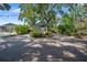 Charming home featuring lush landscaping, inviting entryway, and a driveway with ample parking at 1304 Withlacoochee St, Safety Harbor, FL 34695