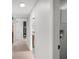 Bright hallway featuring white walls, light wood flooring, and modern design elements throughout the space at 1304 Withlacoochee St, Safety Harbor, FL 34695