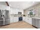 Modern kitchen with stainless steel appliances, white cabinets, and a patterned backsplash at 1304 Withlacoochee St, Safety Harbor, FL 34695