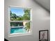 View of the refreshing pool and backyard oasis from inside the home's window at 1304 Withlacoochee St, Safety Harbor, FL 34695