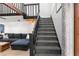 Carpeted staircase with modern black railing, connecting living spaces in the home at 1304 Withlacoochee St, Safety Harbor, FL 34695