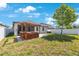 Spacious backyard featuring pergola covered hot tub, brick paver patio and green grass area at 13213 Haystack Ct, Riverview, FL 33579