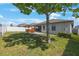 Spacious backyard with well-maintained lawn, privacy fence, covered patio, and pergola with hot tub at 13213 Haystack Ct, Riverview, FL 33579