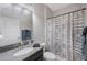 Bathroom featuring granite countertop, modern sink fixtures, and a stylish patterned shower curtain at 13213 Haystack Ct, Riverview, FL 33579