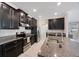 Modern kitchen with stainless steel appliances, granite countertops, a kitchen island, and tile flooring at 13213 Haystack Ct, Riverview, FL 33579