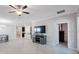 Spacious living room with tile flooring open to the dining area and kitchen providing an open concept living space at 13213 Haystack Ct, Riverview, FL 33579