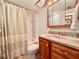Bathroom featuring a sink vanity, mirror, toilet, and shower/tub combination at 1332 Pasadena S Ave # 208, South Pasadena, FL 33707