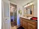 Bathroom featuring a sink vanity, mirror, toilet, shower, and storage at 1332 Pasadena S Ave # 208, South Pasadena, FL 33707