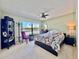 Comfortable bedroom with a large window overlooking the pool area at 1332 Pasadena S Ave # 208, South Pasadena, FL 33707