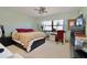 Spacious bedroom featuring a large window, ceiling fan, dresser, and desk area at 1332 Pasadena S Ave # 208, South Pasadena, FL 33707