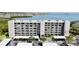 Waterfront condo building with covered parking and lush landscaping at 1332 Pasadena S Ave # 208, South Pasadena, FL 33707