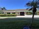 A building exterior shows the front door and a well maintained grassy area at 1332 Pasadena S Ave # 208, South Pasadena, FL 33707