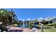 Scenic exterior view showcasing a tranquil pond and lush landscaping on a sunny day at 1332 Pasadena S Ave # 208, South Pasadena, FL 33707