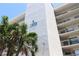 Close up view of waterfront condo building with palms at 1332 Pasadena S Ave # 208, South Pasadena, FL 33707