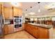 A kitchen with granite counters and stainless appliances overlooks a large seating area at 1332 Pasadena S Ave # 208, South Pasadena, FL 33707