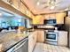 Modern kitchen featuring granite countertops and stainless steel appliances at 1332 Pasadena S Ave # 208, South Pasadena, FL 33707