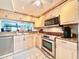 Updated kitchen featuring stainless steel appliances and granite counters at 1332 Pasadena S Ave # 208, South Pasadena, FL 33707