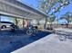 A bike rack is under a carport with parking for a car and motorcycle at this community at 1332 Pasadena S Ave # 208, South Pasadena, FL 33707