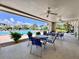 Covered poolside patio with tables and chairs, perfect for relaxing by the community pool at 1332 Pasadena S Ave # 208, South Pasadena, FL 33707