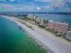 Aerial view showcases luxury beachfront condos, pristine beach, and turquoise waters at 1340 Gulf Blvd # 16A, Clearwater Beach, FL 33767