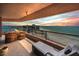 Spacious balcony with comfortable seating offers stunning ocean views at sunset at 1340 Gulf Blvd # 16A, Clearwater Beach, FL 33767