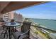 Condo balcony featuring seating area and views of water and neighborhood at 1340 Gulf Blvd # 16A, Clearwater Beach, FL 33767
