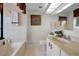 Cozy bathroom with tub, vanity, and decorative mirror at 1340 Gulf Blvd # 16A, Clearwater Beach, FL 33767