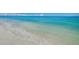 Scenic view of a serene beach with clear turquoise water and soft, white sand at 1340 Gulf Blvd # 16A, Clearwater Beach, FL 33767