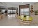 Open dining and living area with tile flooring, balcony access, and views of the bay at 1340 Gulf Blvd # 16A, Clearwater Beach, FL 33767