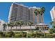 A beautiful view of the exterior of the building, showcasing its height, design, balconies and lush landscaping at 1340 Gulf Blvd # 16A, Clearwater Beach, FL 33767