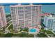 Beachfront condo building featuring a refreshing pool and lush greenery at 1340 Gulf Blvd # 16A, Clearwater Beach, FL 33767