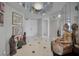Bright condo hallway featuring tile floors, mirrored walls, a chandelier, and decorative statues at 1340 Gulf Blvd # 16A, Clearwater Beach, FL 33767