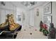 Bright condo hallway featuring tile floors, mirrored walls, white doors, and unique decorative statues at 1340 Gulf Blvd # 16A, Clearwater Beach, FL 33767
