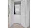 Laundry closet with stacked washer and dryer behind shuttered doors at 1340 Gulf Blvd # 16A, Clearwater Beach, FL 33767