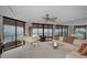 Bright and spacious living room featuring floor-to-ceiling windows with stunning ocean views and a grand white piano at 1340 Gulf Blvd # 16A, Clearwater Beach, FL 33767