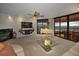 Bright living room with fireplace, floor to ceiling windows, ocean view, white piano and comfortable seating at 1340 Gulf Blvd # 16A, Clearwater Beach, FL 33767