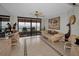 Living room area with tiled floors, ceiling fan, sliding glass doors to the balcony, and a water view at 1340 Gulf Blvd # 16A, Clearwater Beach, FL 33767