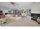 A bright and spacious living room with ocean views, a fireplace, and a white sectional sofa and piano at 1340 Gulf Blvd # 16A, Clearwater Beach, FL 33767