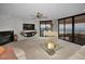 Bright and spacious living room featuring floor-to-ceiling windows with ocean views and a grand white piano at 1340 Gulf Blvd # 16A, Clearwater Beach, FL 33767