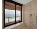 Walk-in shower with ocean view window, tile accents and rainfall shower head at 1340 Gulf Blvd # 16A, Clearwater Beach, FL 33767
