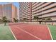 Outdoor tennis court with surrounding landscaping and stunning high-rise buildings at 1340 Gulf Blvd # 16A, Clearwater Beach, FL 33767