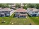 Aerial view of the backyard with a spacious lawn and covered patio at 14137 Wake Robin Dr, Brooksville, FL 34604