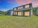 Spacious backyard featuring a covered patio and well-maintained lawn at 14137 Wake Robin Dr, Brooksville, FL 34604