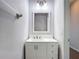 Clean bathroom showcases a white vanity with dual sinks, a framed mirror, and updated lighting at 14137 Wake Robin Dr, Brooksville, FL 34604